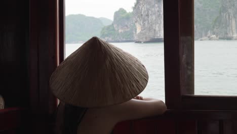 Ha Long Bay cruise woman in traditional non la Vietnamese hat Vietnam trip excursion tourist