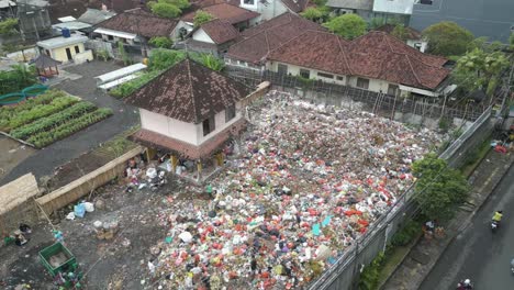 high up aerial of a junk yard in suburban den pasar, bali, indonesia