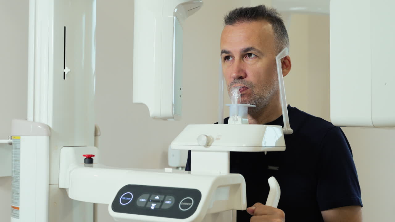 Panoramic scan of man's jaw by x-ray scanner in dental clinic. Scanner rotation. Modern equipment for diagnostics and research