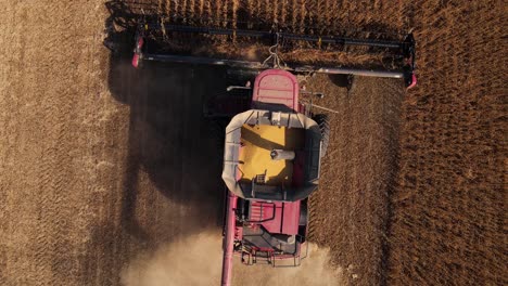 aerial rise up of combine harvesting soybeans in united states, michigan