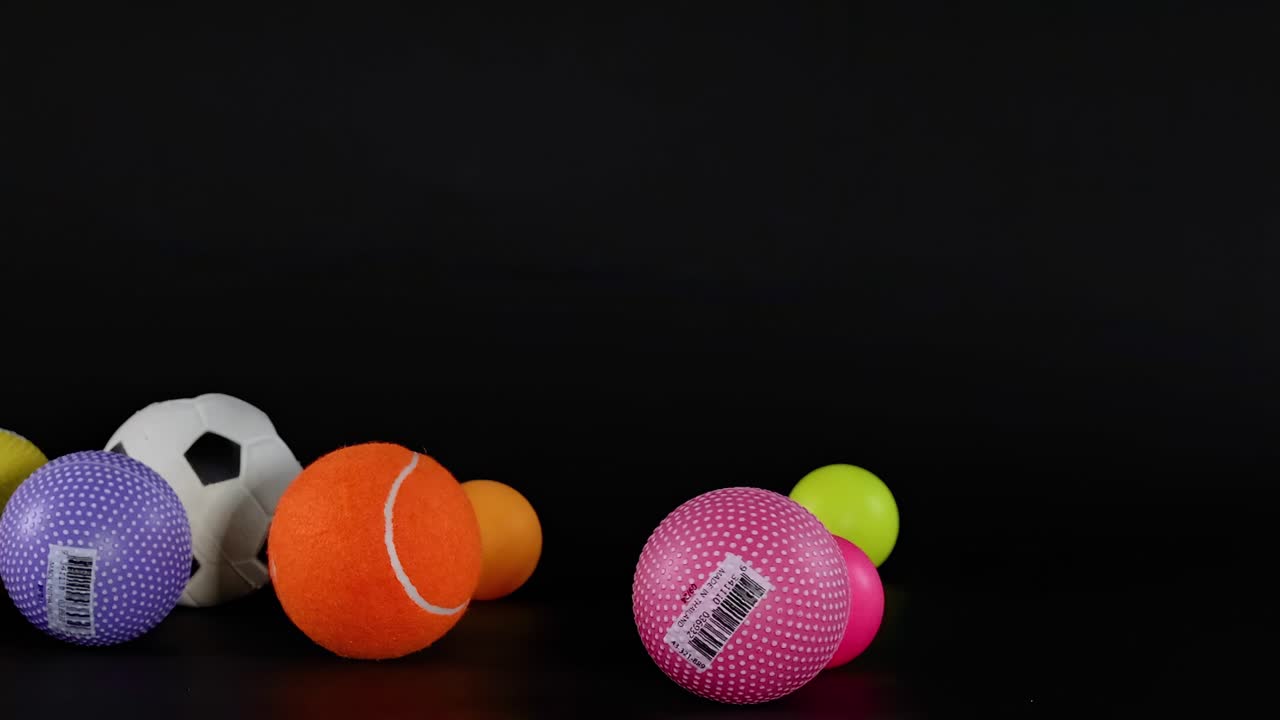 Assortment of Colorful Balls on Black Background