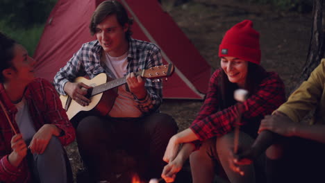 friends camping and making memories around a campfire