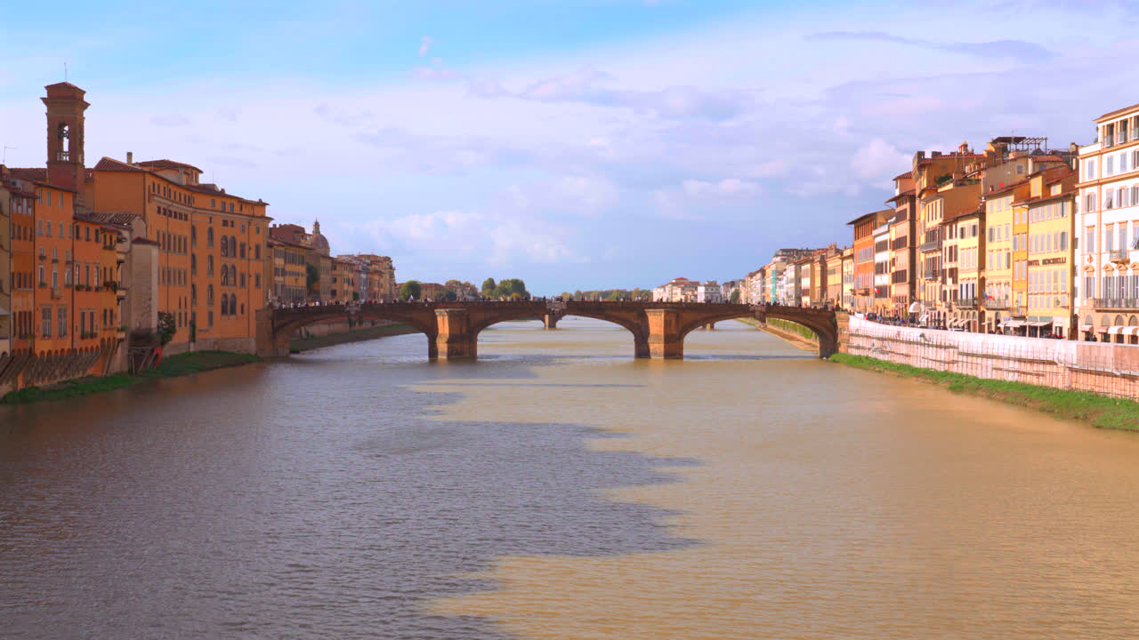 Arno river through Florence city reflections of renaissance era bridges and houses