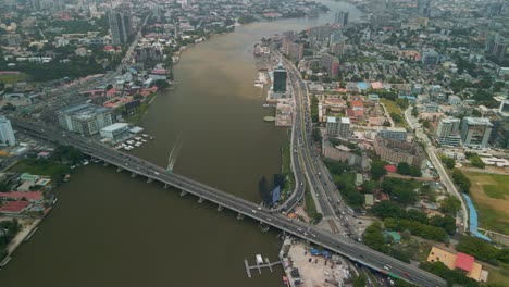 Traffic-and-cityscape-of-Victoria-Island,-Lagos,-Nigeria-featuring-Falomo-Bridge,-Lagos-Law-school-and-the-Civic-centre-tower