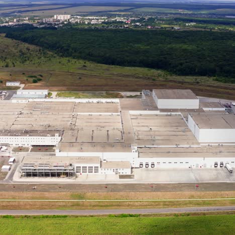 large industrial territory in nature. modern plant with car parking from above. huge manufacturing in the countryside. aerial view