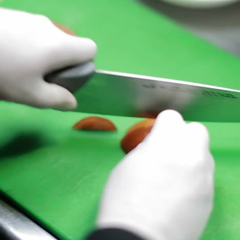 chef hands cutting tomato