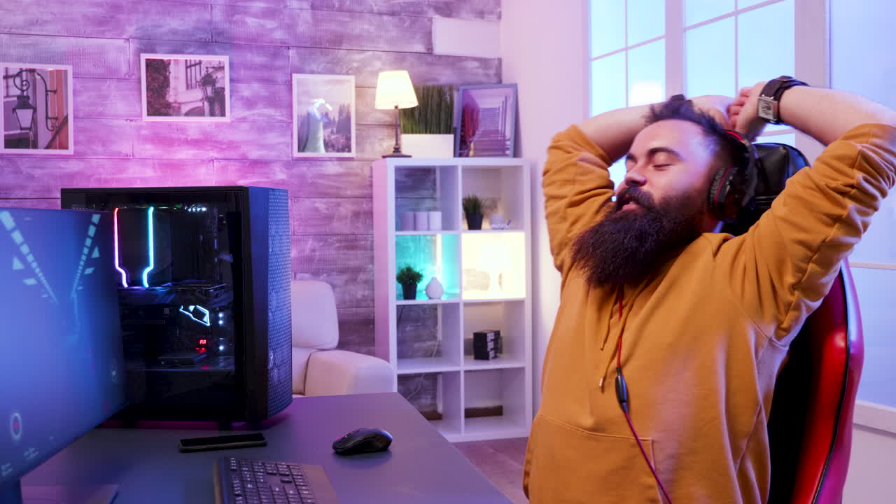 Man Gaming at Computer with Headphones