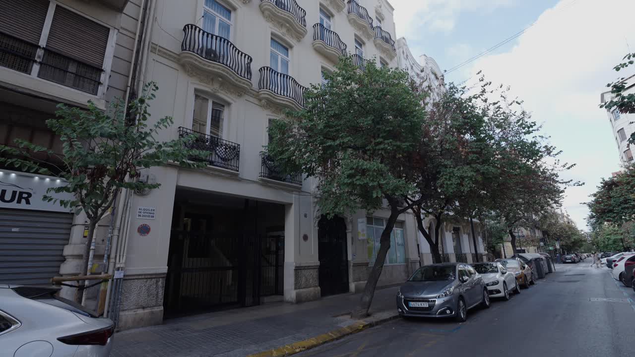 European Building with Balconies and Urban Street Scene