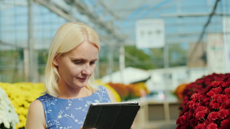 woman uses tablet for flower inventory