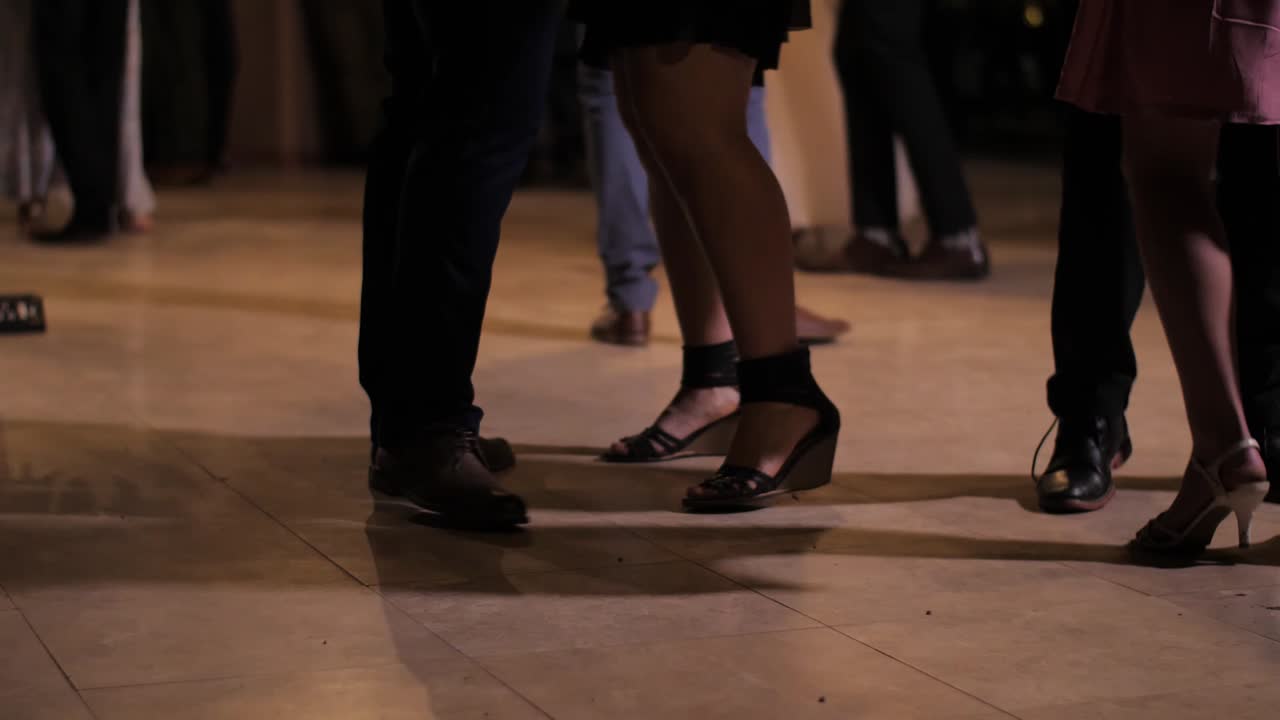 Several people slow dancing with partners