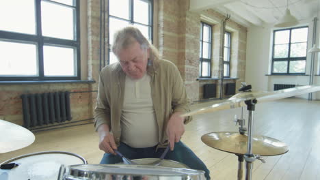 senior musician practicing drumset
