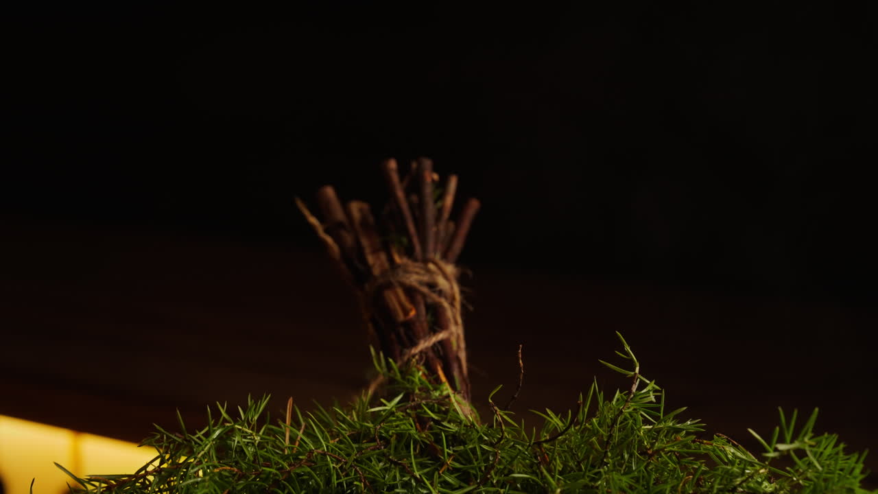 Close up of a decorative arrangement of twigs, string and plants