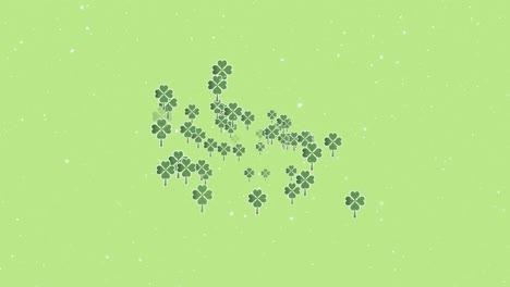 animation of snow falling over clover leaves on green background