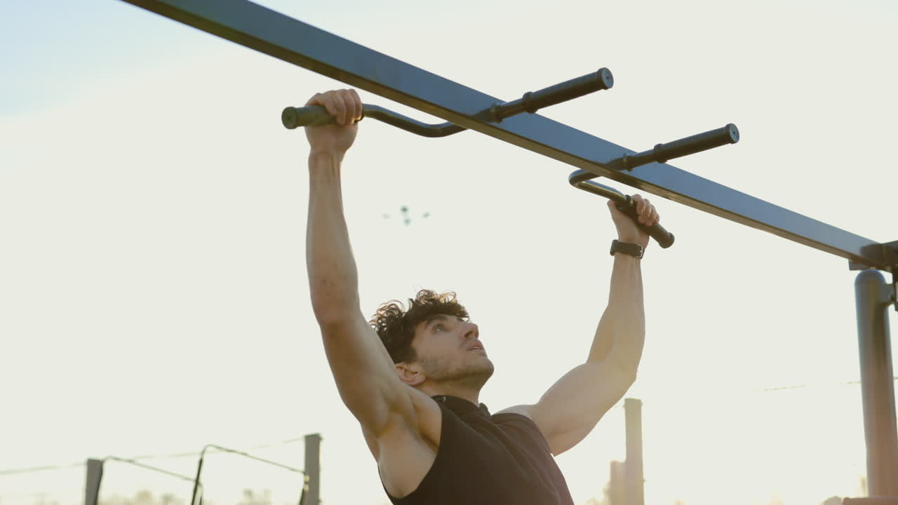 Man Performing Pull-ups at Outdoor Gym