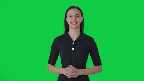 Happy-Indian-female-news-anchor-smiling-Green-screen