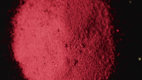 video of close up of red powder with copy space on black background