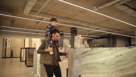 Happy Father Carrying Son on Shoulders at Shop of Kitchen Materials and Tile Happy Father Carrying Son on Shoulders at Shop of Kitchen Materials and Tile High Quality Footage