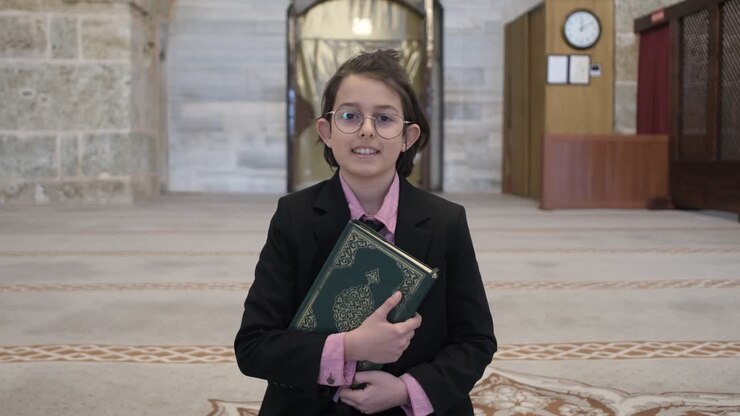 Boy holding quran