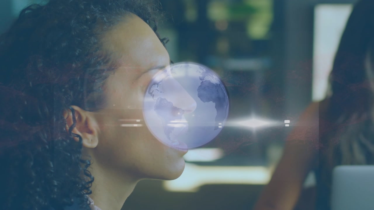 Animation of spinning globe over close up of african american woman at office