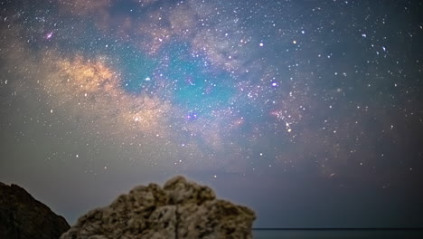 Time-lapse-at-night-of-starry-sky-in-Cyprus-aphrodites-rock-viewpoint-with-shooting-stars