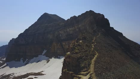 Drone-shot-following-a-trail-up-the-ridgeline-towards-the-top-of-Mount-Timpanogos