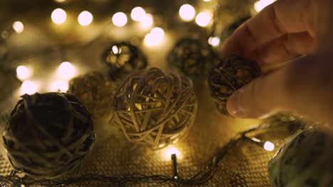 close-up christmas garland and handmade balls on a playd with golden lights. christmas concept. home decor