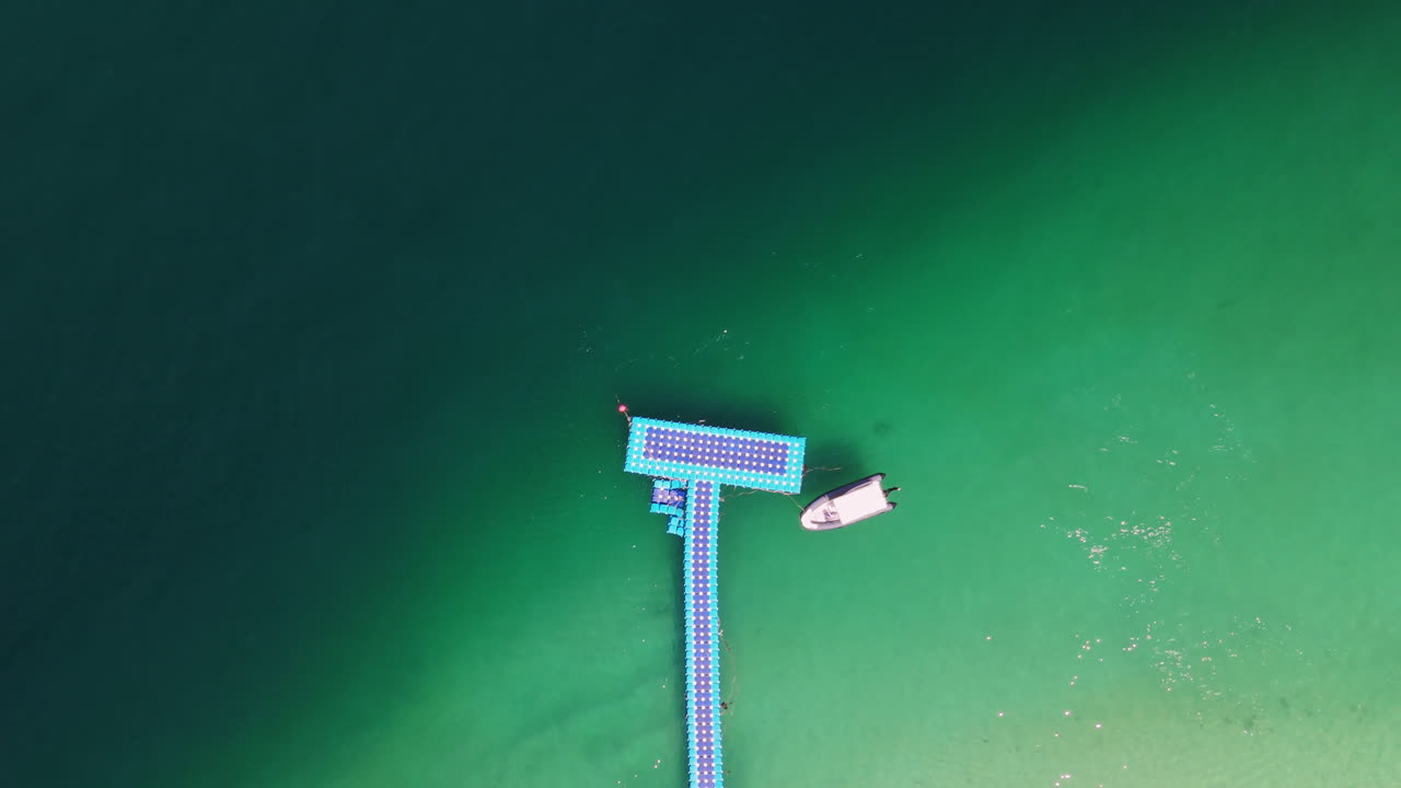 Floating Pier and Boat on a Green Lake
