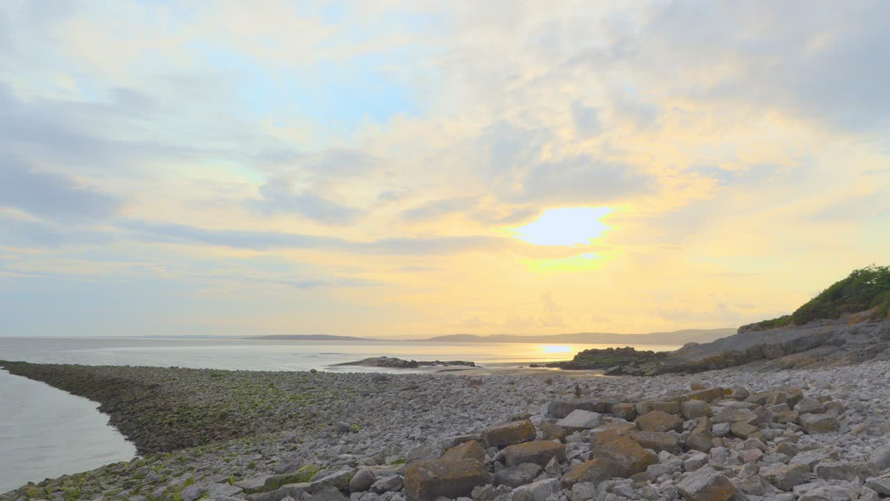 Time lapse fast moving clouds at sunset 30x normal speed using 1 second exposures at Walduck's Wall, Silverdale, Lancashire, UK