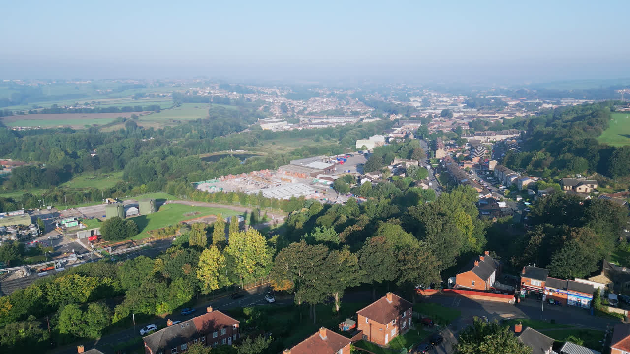 Dewsbury Moore Council estate, UK, as seen from a drone, reveals red-brick housing and Yorkshire's industrial scenery on a sunny summer morning