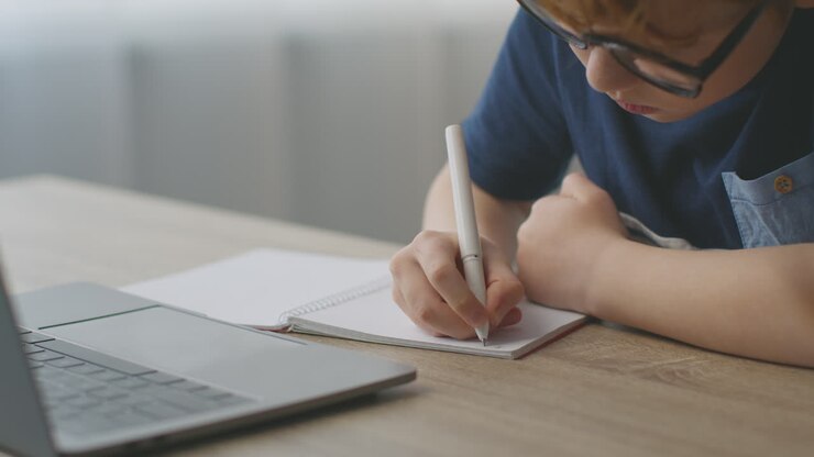Child Doing Homework at Laptop