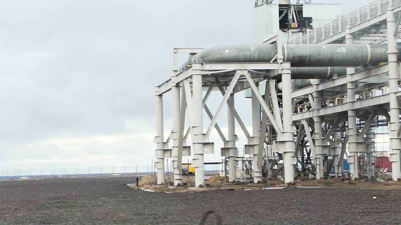 Industrial Construction Site with Pipelines and Metal Structures