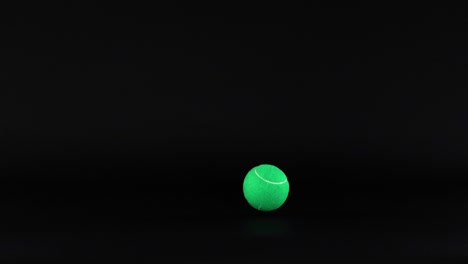 a tennis ball moves against a dark background