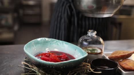 chef preparing and serving traditional russian borscht
