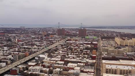 an aerial drone shot, panning left over sunset park brooklyn