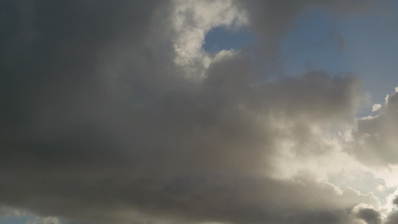 Cloudscape Timelapse, White Clouds Back Lit by the Sun - Low Angle Static