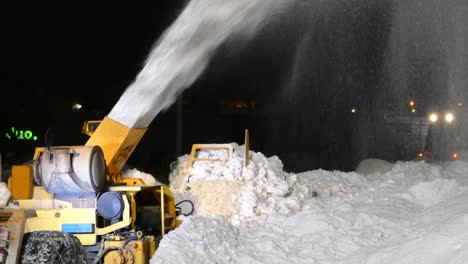 close-up shot of snowplow snow removal workers driving trucks cleaning streets removing snow with snowblower heavy duty machinery equipment trucks, montreal, quebec, canada