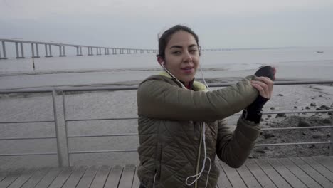 cheerful young hindu girl stretching hands on seaside