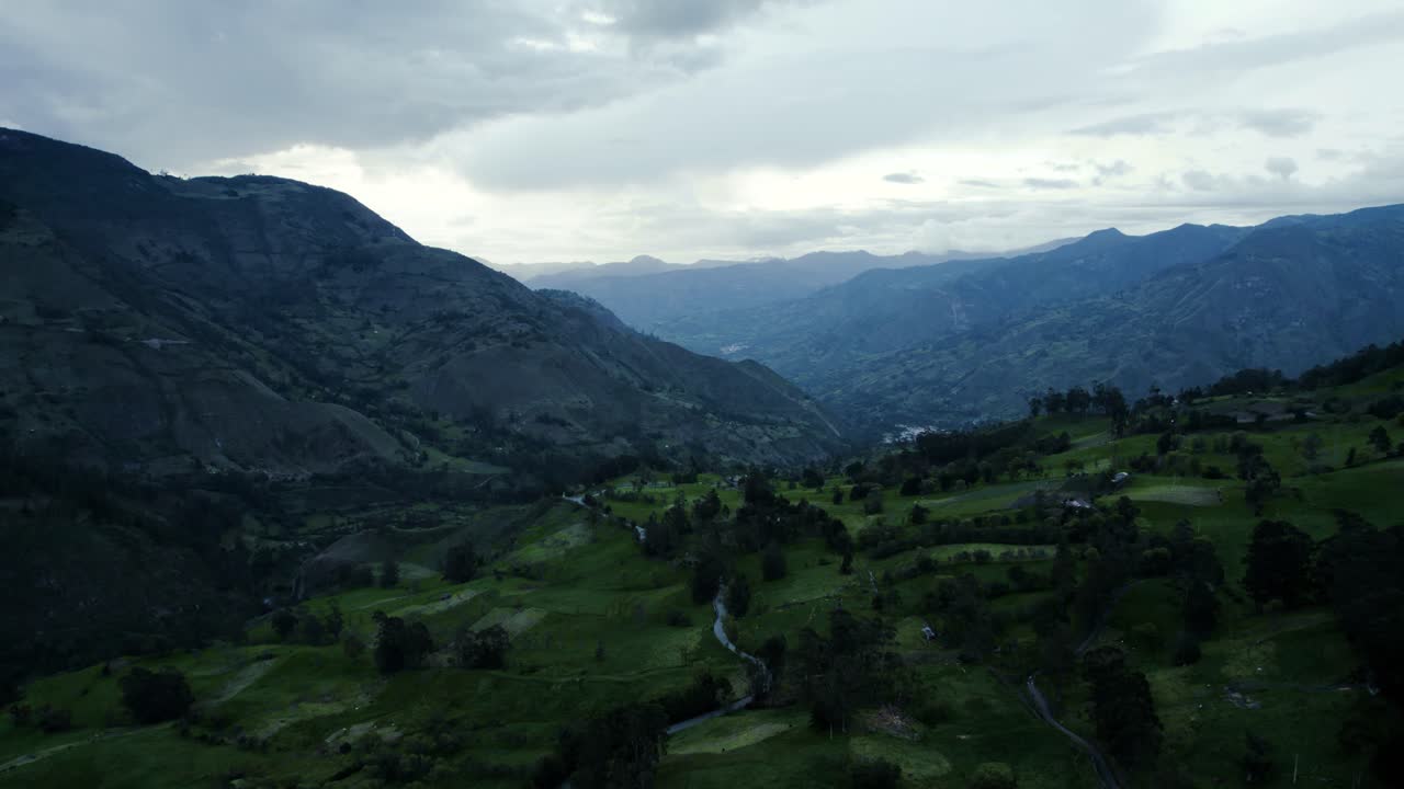 Aerial footage captured by a drone at a height of 2800m reveals a breathtaking vista of endless mountains, enveloped by lush green landscapes and dramatic clouds, creating an awe-inspiring scene