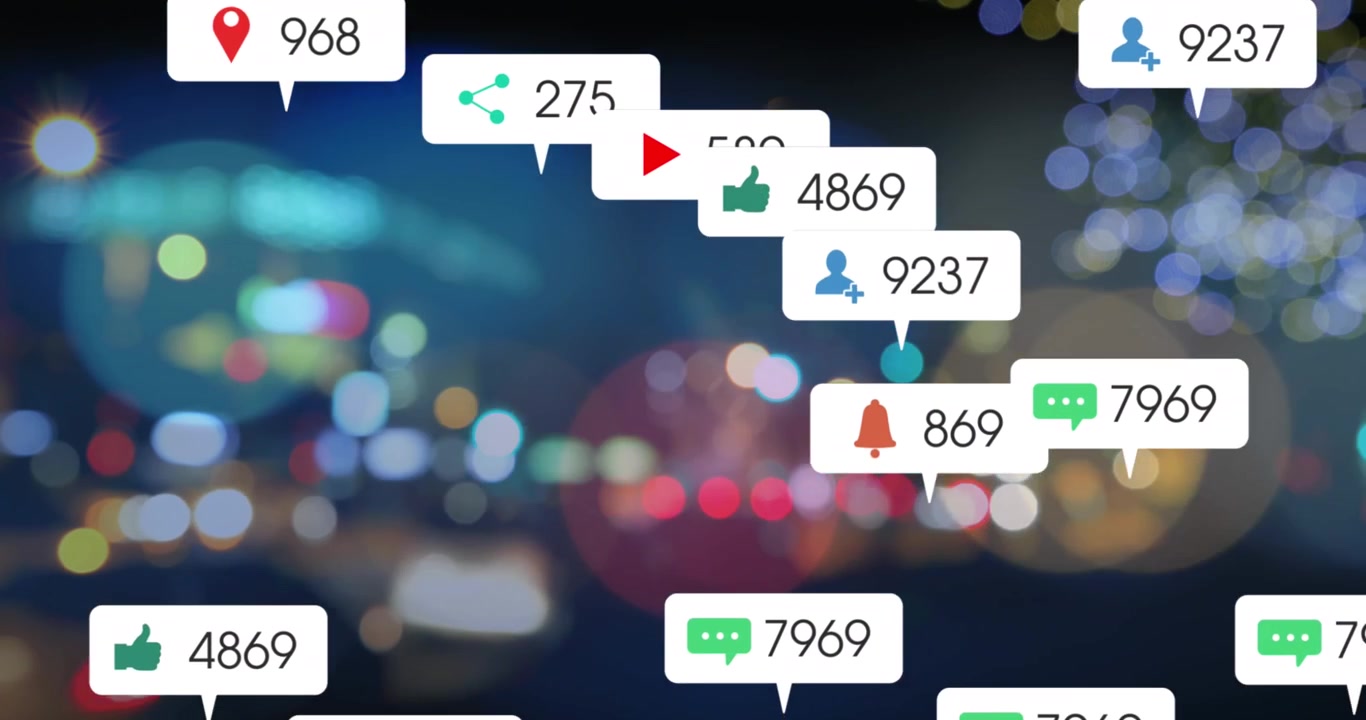 Animation of social media icons on multiple speech bubbles over blurred view of night city traffic