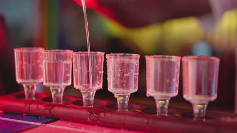 a bartender pouring shots of alcohol