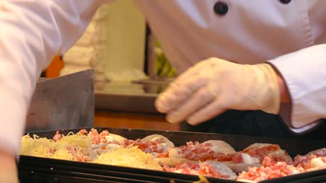 vendor adding cheese to flatbreads