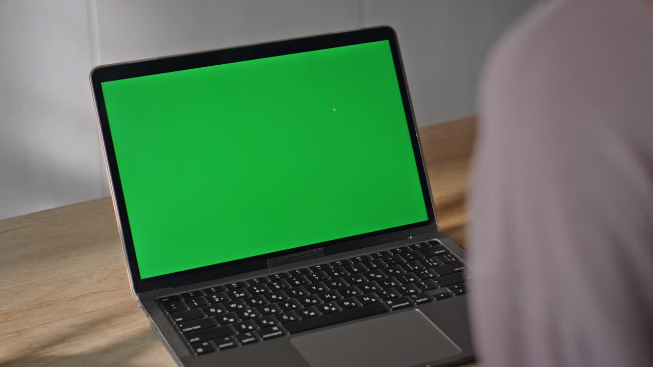 Unrecognizable student studying greenscreen laptop sitting home close up.