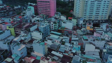 early morning drone fly in over modern urban rooftops towards illuminated french colonial catholic church