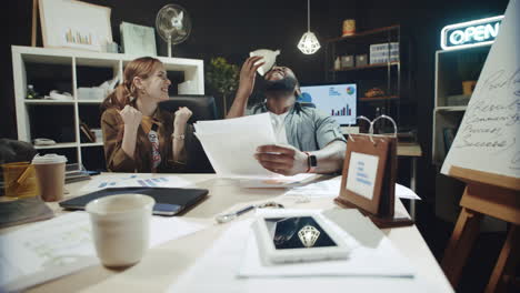 happy business woman and afro man finding right solution in documents in office.