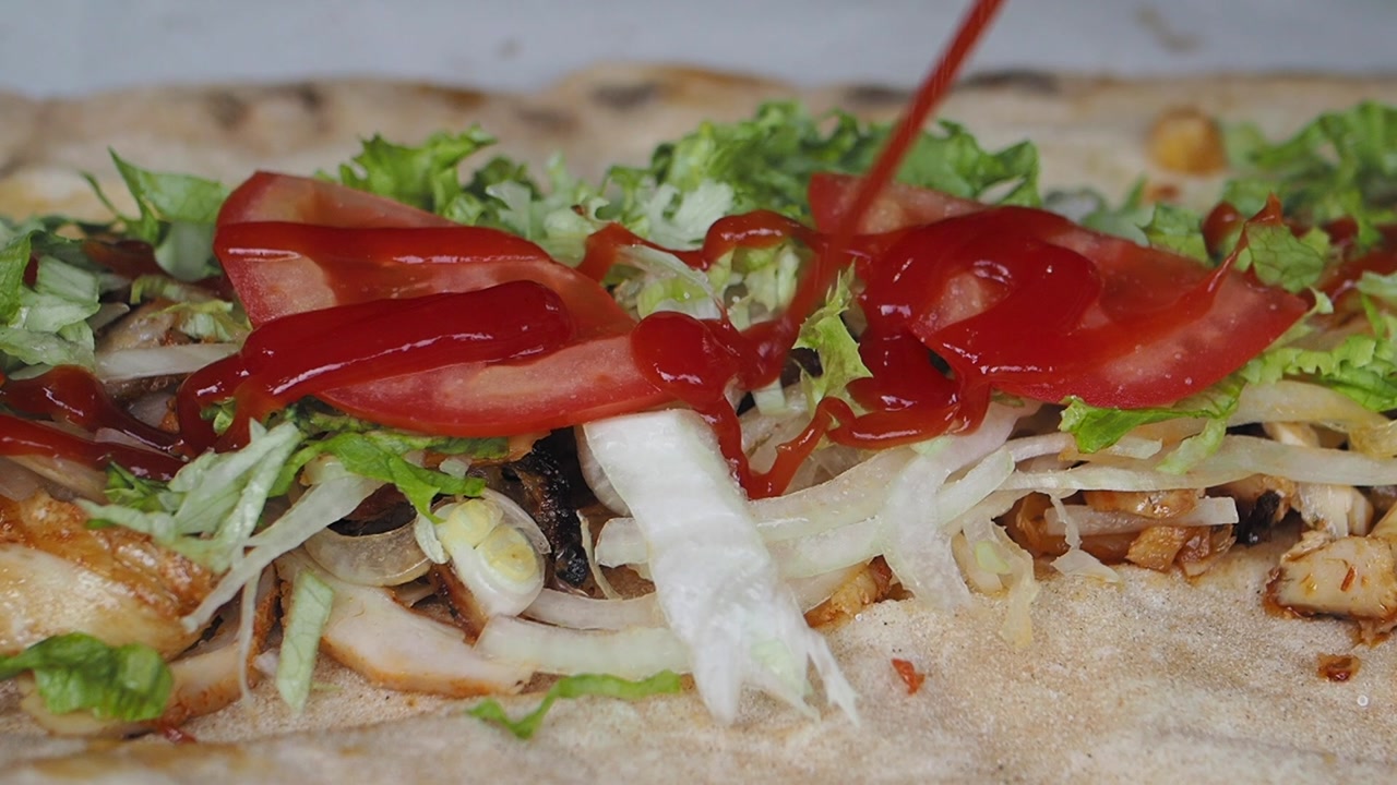 Preparing a Delicious Chicken Kebab Wrap with Ketchup