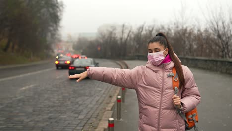 woman waiting for a taxi in the city