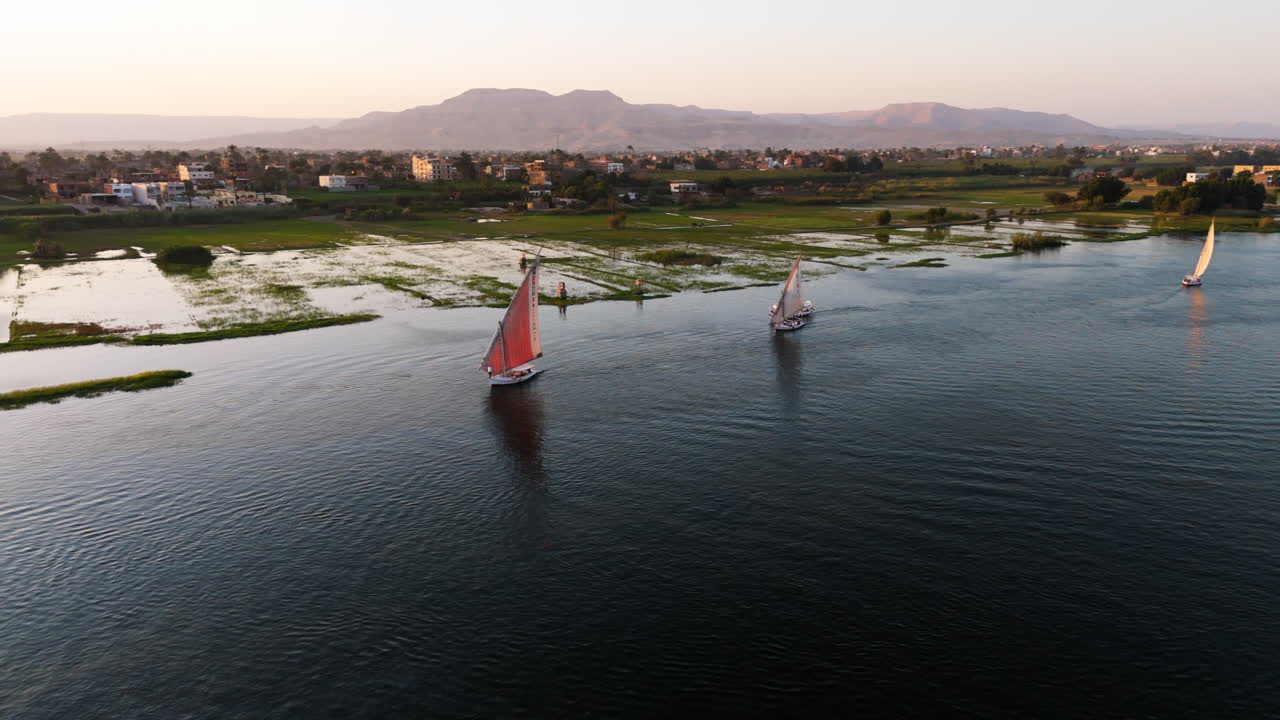 Traditional boat gliding along Nile in Luxor - aerial