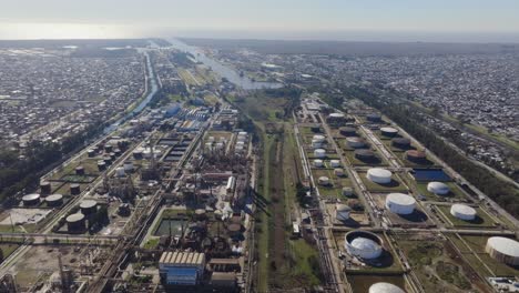 Daytime drone footage of oil and natural gas facility with neighborhood nearby