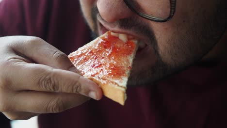 man eating jam toast