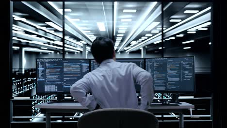 it technician focused on code in a server room